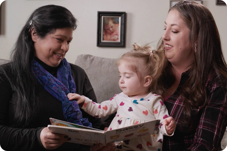 A family support provider and mother playing with a baby