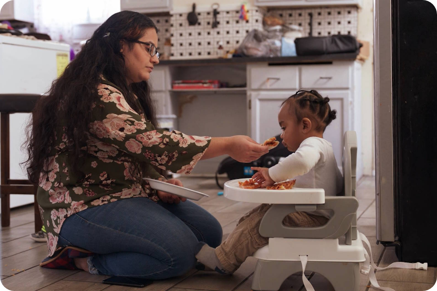 A family support provider and mother playing with a baby